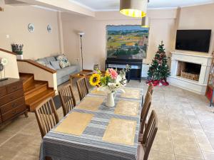 a living room with a table and a christmas tree at Purerest Entire Private Villa in Athens