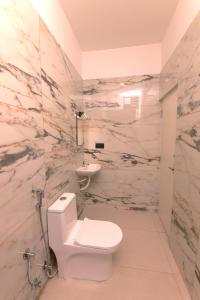 a bathroom with a toilet and a sink at Coastal Calm Inn in Fort Kochi