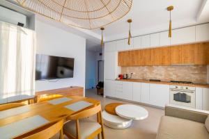 a kitchen with a table and a dining room at Velora Apartments in Năvodari