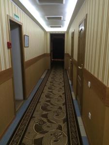 a hallway with a stairway leading to a bathroom at Hotel VIARDO on Timiryazeva 17 in Almetyevsk