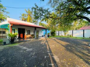 a house with a road in front of it at Kapuwatta Pool Villa in Weligama