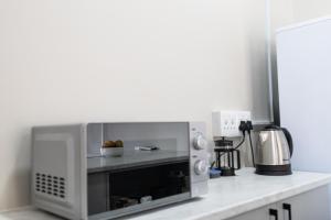 a microwave oven sitting on top of a counter at Archers Guest House in Patentie