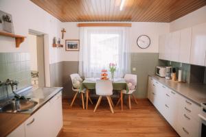 a kitchen with a table and chairs and a window at Alpenblick Gösweiner in Windischgarsten