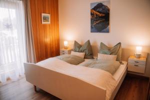 a bedroom with a large bed with two lamps at Alpenblick Gösweiner in Windischgarsten