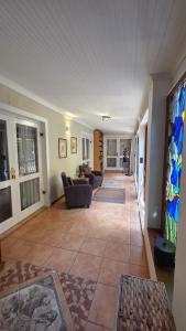 a living room with couches and stained glass windows at TheBlueDoor in Greyton +24 photos