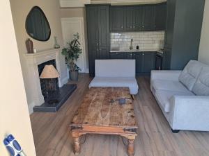 a living room with a couch and a coffee table at Two bed Seaside retreat in Dublin