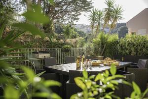 a table with food and drinks on a patio at Résidence la Grande Voile in Banyuls-sur-Mer +23 photos