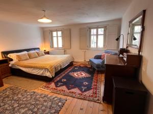 a bedroom with a bed and a couch at Alpine Retreat - Lake Bled in Bled