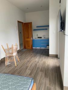 a living room with a chair and a kitchen at Magallanes Escape in Manila