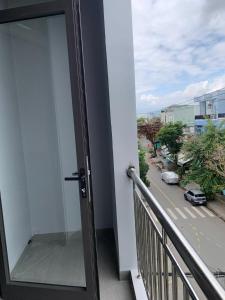 a balcony with a glass door with a view of a street at Magallanes Escape in Manila +1 photo