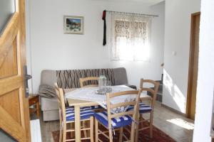 a dining room with a table and chairs at House Drakulić in Korenica