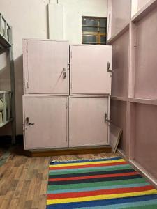 a room with two lockers and a rug at Shillong Backpackers Hostel in Shillong +1 photo