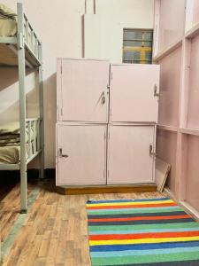 a room with two bunk beds and a rug at Shillong Backpackers Hostel in Shillong