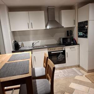 a kitchen with a table and a stove top oven at Relax-Apartment mit Sauna in Klagenfurt