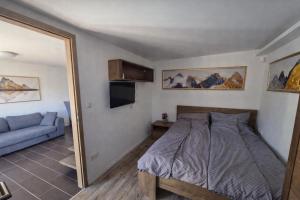a bedroom with a bed and a couch and a mirror at Badacsonyi rege in Badacsonytördemic