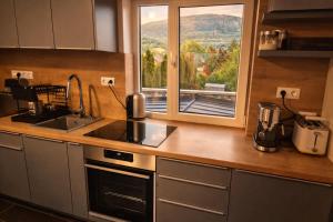 a kitchen with a sink and a window with a view at Badacsonyi rege in Badacsonytördemic
