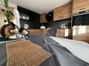 a kitchen with a table with a counter top at Apart Alpenflair 74 in Fliess