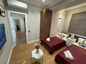 a hotel room with two beds and a table at Maiden Tower Prestige in Baku