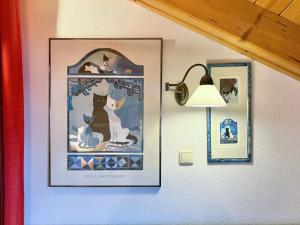 a picture hanging on a wall with a lamp at Sonnenhof Seeg 19 in Seeg