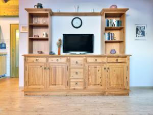 a large wooden entertainment center with a television on it at Sonnenhof Seeg 19 in Seeg +31 photos