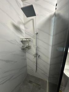 a bathroom with a shower with a solar panel on the ceiling at Solis Residence Batumi in Batumi +3 photos