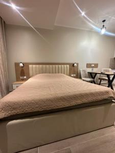 a bedroom with a large bed with lights on it at Solis Residence Batumi in Batumi