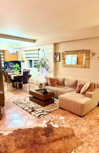 a living room with a couch and a table at luxury house airport in Koropi