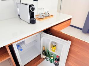 an open refrigerator with beer bottles in it at RUBO Hotel in Shumen