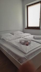 a large white bed with two towels on it at Apartament OLIWIA 5 in Nowy Targ