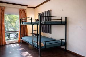 two bunk beds in a room with a window at 88 Ehome Noibai Airport in Hanoi