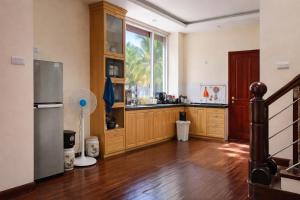 a kitchen with a refrigerator and a large window at 88 Ehome Noibai Airport in Hanoi