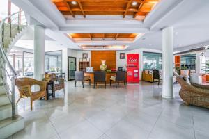a living room with a table and chairs at Suan Palm Garden View in Rayong