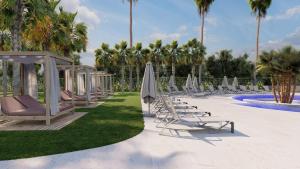 a group of chairs and umbrellas next to a pool at Cala Millor Garden Hotel - Adults Only in Cala Millor