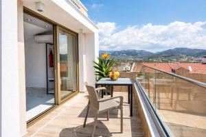 a balcony with a table and chairs and a view at MPL Apartments & maisonettes in Limenaria