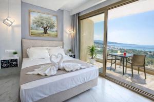 a bedroom with a bed with two swans on it at MPL Apartments & maisonettes in Limenaria