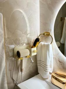 a bathroom with a mirror and a white towel at luxury house airport in Koropi +30 photos