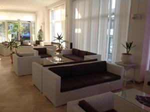 a living room with couches and a table at Hotel Continental in Pesaro