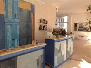 a kitchen with a blue and white counter in a room at Hotel Continental in Pesaro