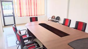 a conference room with a wooden table and chairs at katunayake city apartment in Katunayaka