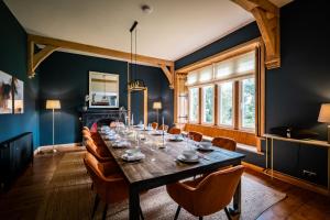a dining room with a long table and chairs at The Old Vicarage Irton in Parton