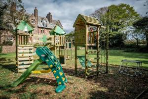 a playground with a slide and a play structure at The Old Vicarage Irton in Parton