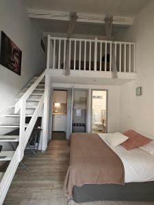 a bedroom with a loft bed and a staircase at Auberge Des Pins in Tourrettes