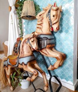 a statue of two horses on a wall at Casa 1895 , Boutique Stay in a Historic Townhouse near the Beer Fountain in Žalec