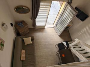 an overhead view of a living room with a couch and stairs at Auberge Des Pins in Tourrettes