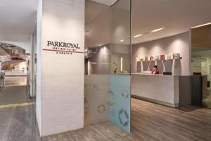 a restaurant with a counter with a person in the background at PARKROYAL Serviced Suites Singapore in Singapore +35 photos