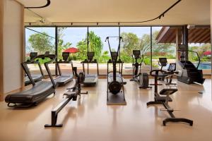 a gym with a bunch of treadmills and machines at PARKROYAL Serviced Suites Singapore in Singapore