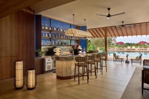 a bar in a villa with a pool at PARKROYAL Serviced Suites Singapore in Singapore