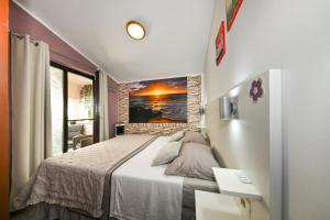 a bedroom with a bed and a painting on the wall at AP Silvija in Zadar