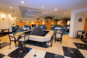 a restaurant with a fountain in the middle of a room at Cleopatra Hotel in Aswan