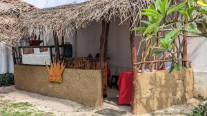 a small hut with a table and a red table cloth at katunayake city apartment in Katunayaka